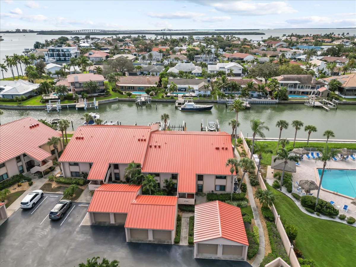 Aerial of the 4730 building, private garages, canal and community pool