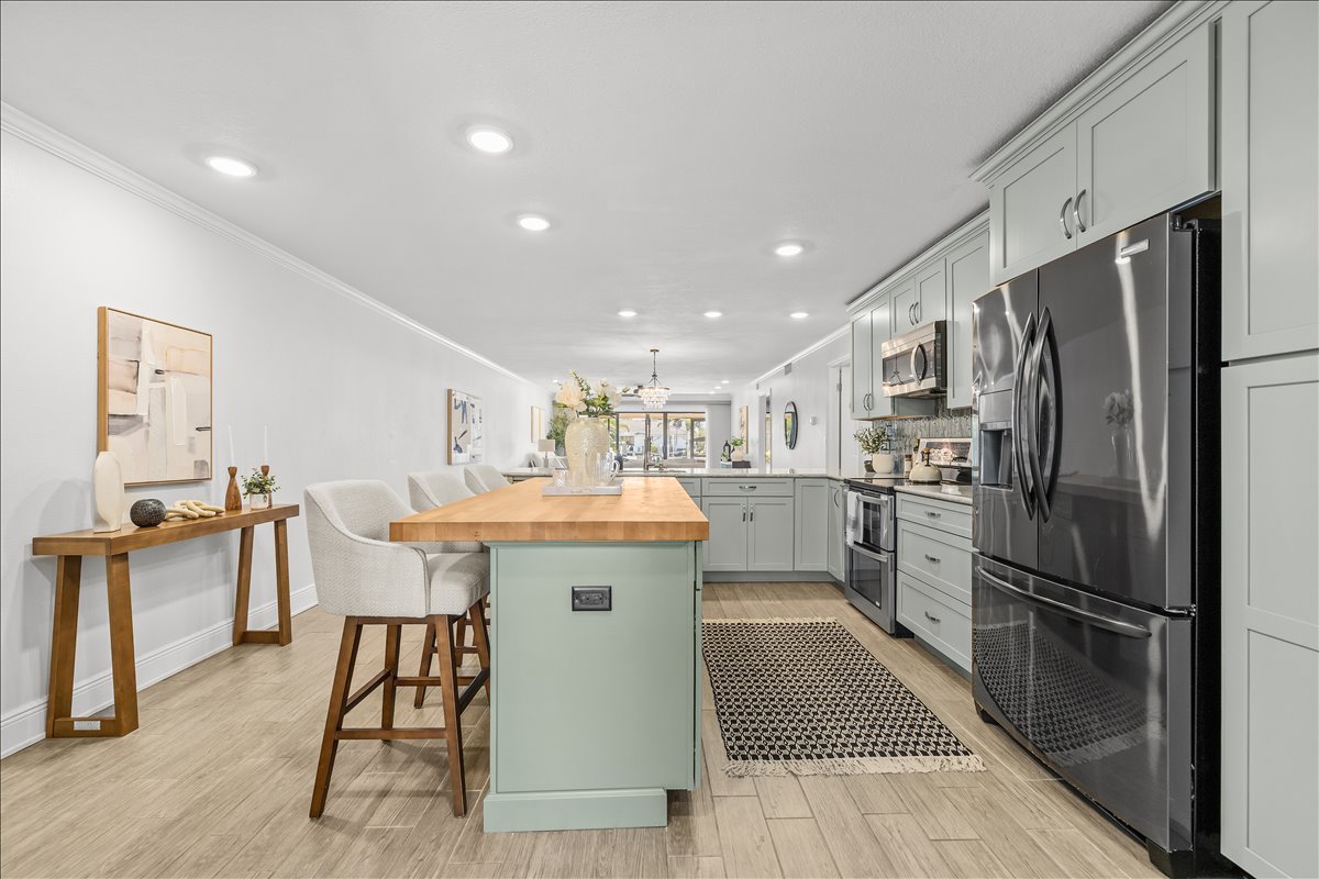 Open kitchen with butcher-block island and stainless appliances