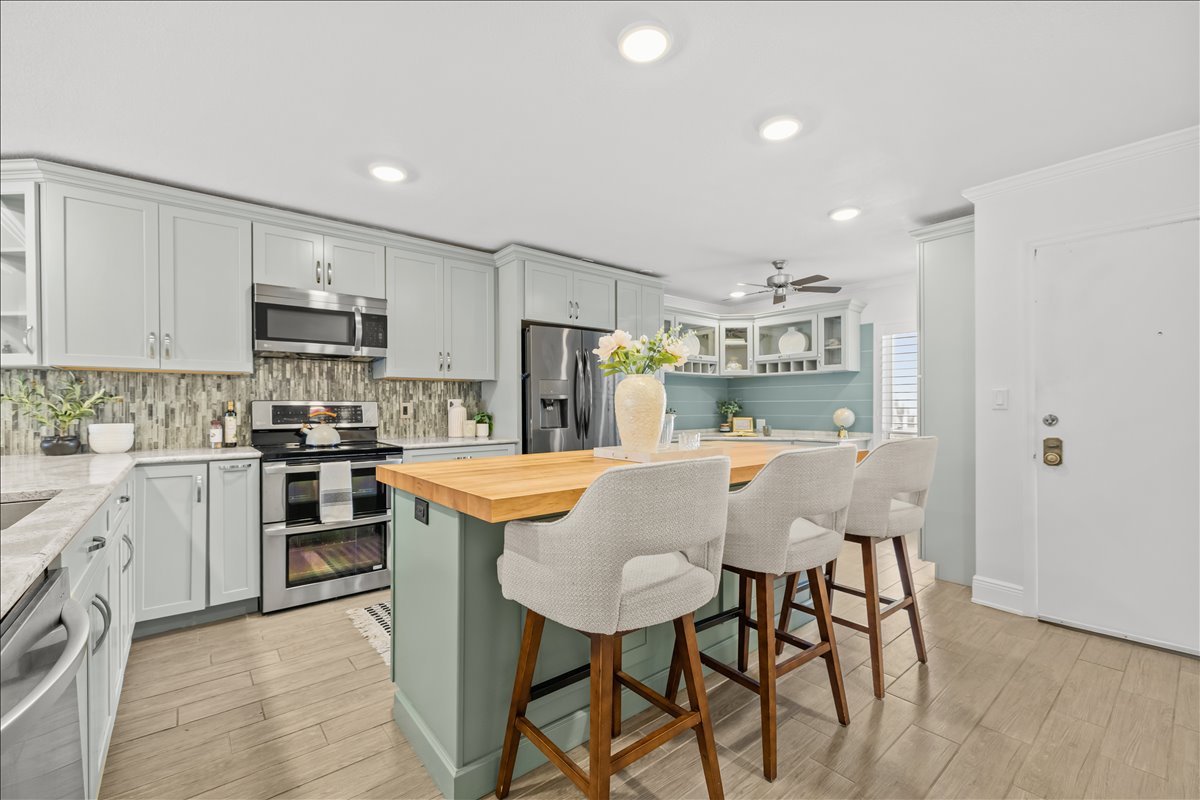 Kitchen with butcher-block island, custom tile backsplash and double oven, 4730 Brittany Dr S #36