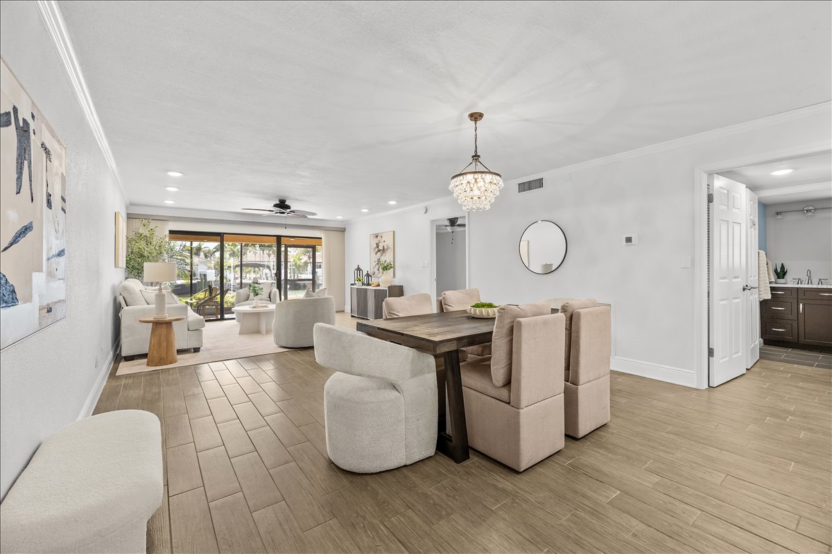 Open dining area with chandelier and coastal styling, 4730 Brittany Dr S #36