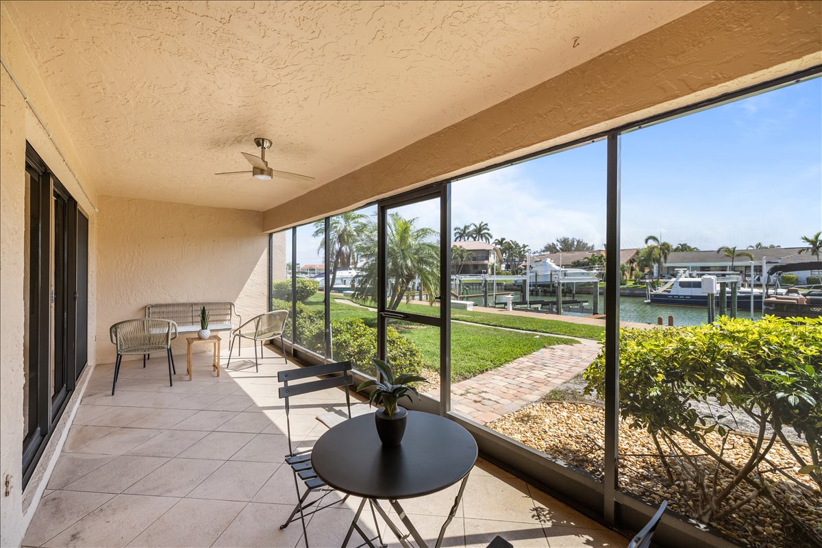 Screened lanai with canal and boat-lift views, 4730 Brittany Dr S #36