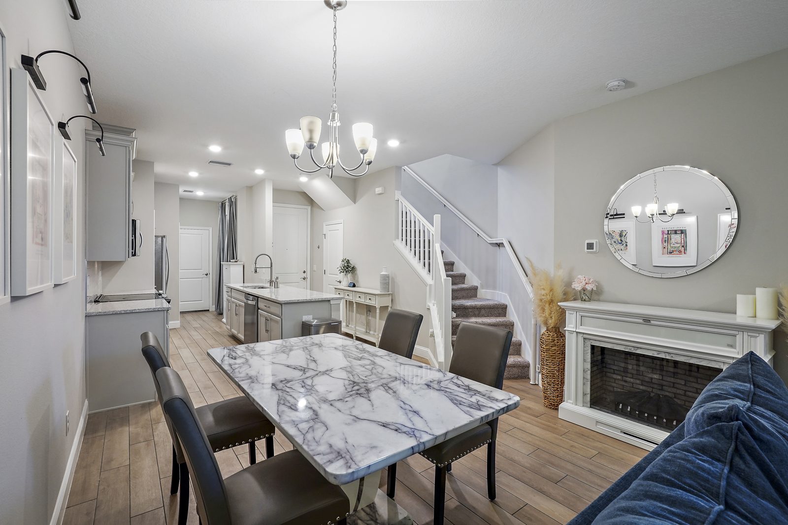 Dining and living area with fireplace and staircase